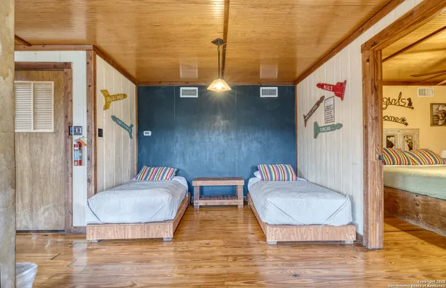 a bedroom with a large bed and a chandelier