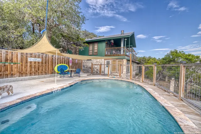a backyard of a house with barbeque oven table and chairs