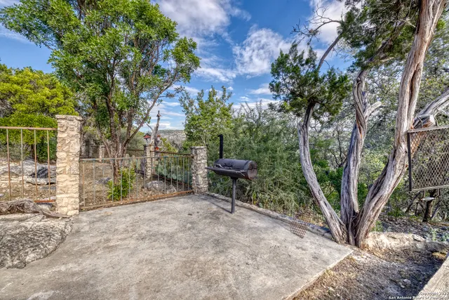 a view of a balcony with two chairs and a potted plant