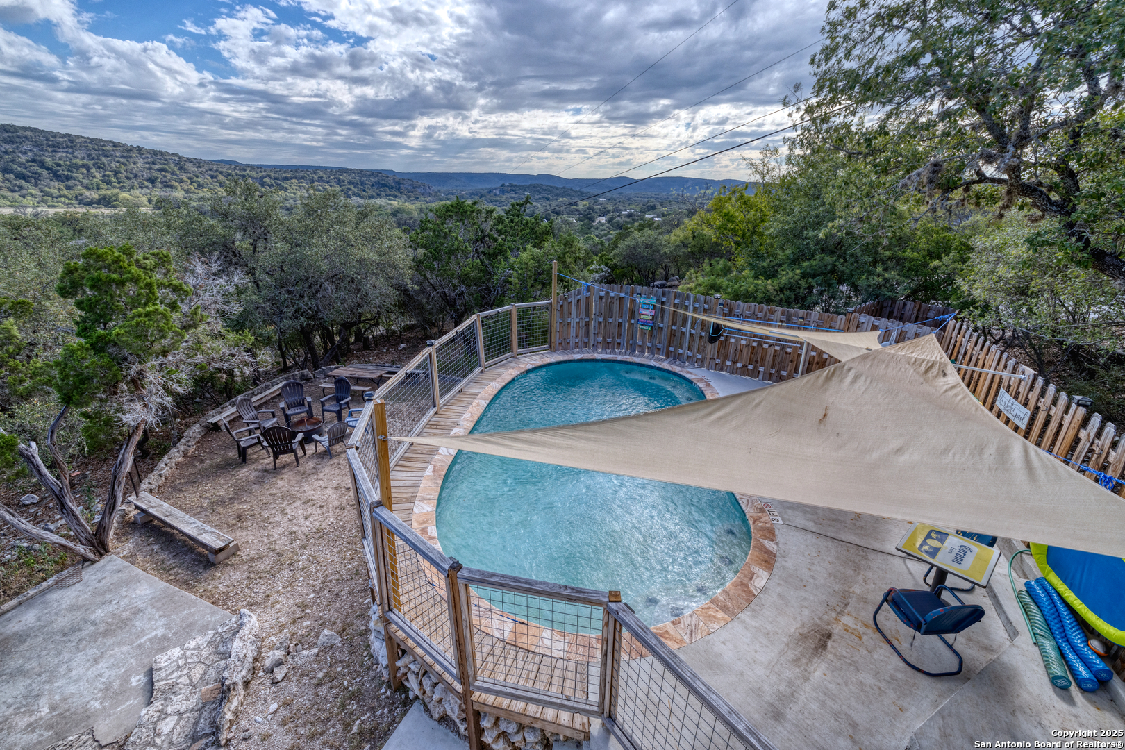186 Cat Claw Mountain Road Concan, TX 78838 - Photo 28 of 31 a view of a balcony with two chairs and a potted plant