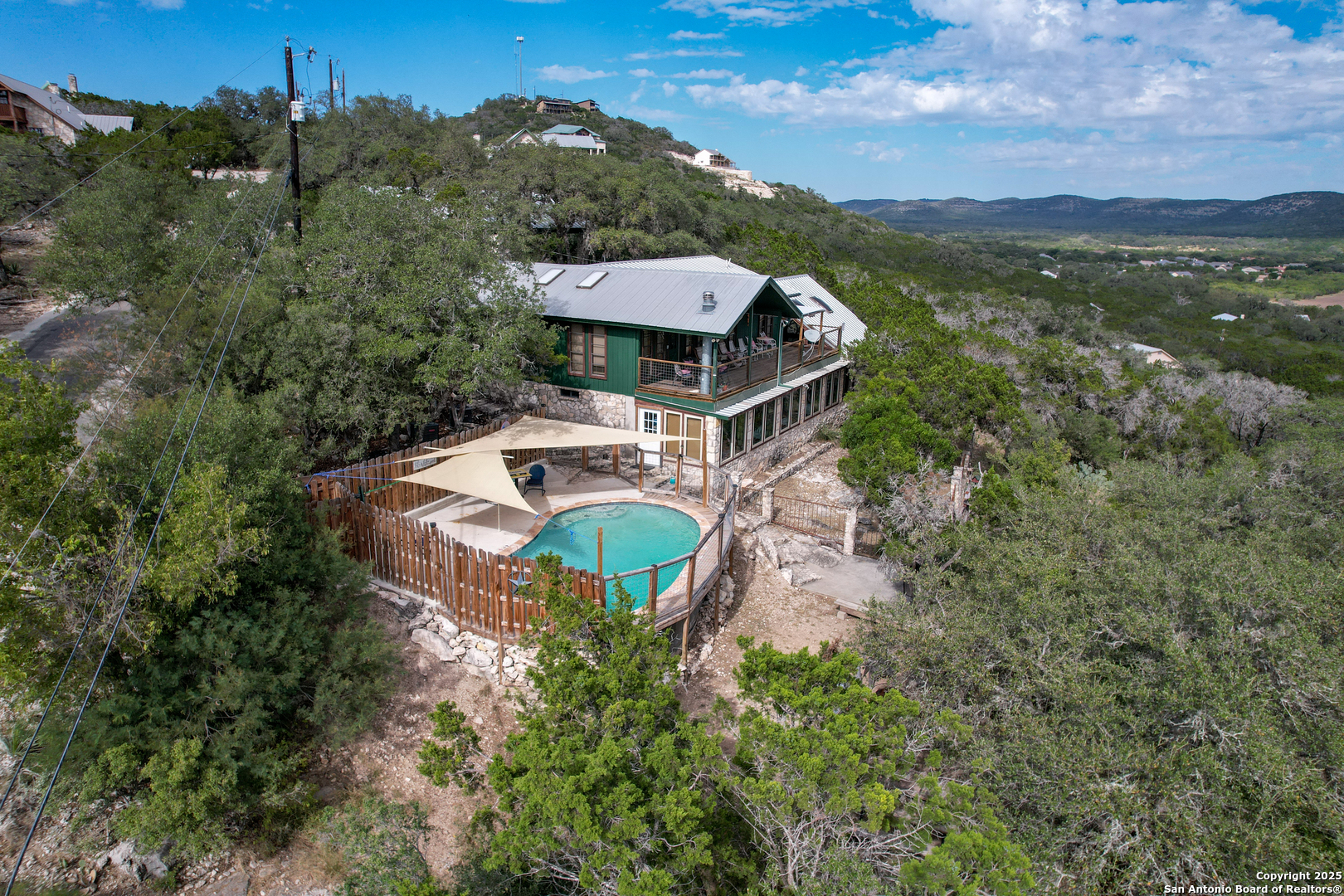 186 Cat Claw Mountain Road Concan, TX 78838 - Photo 3 of 31 an aerial view of a house with a garden