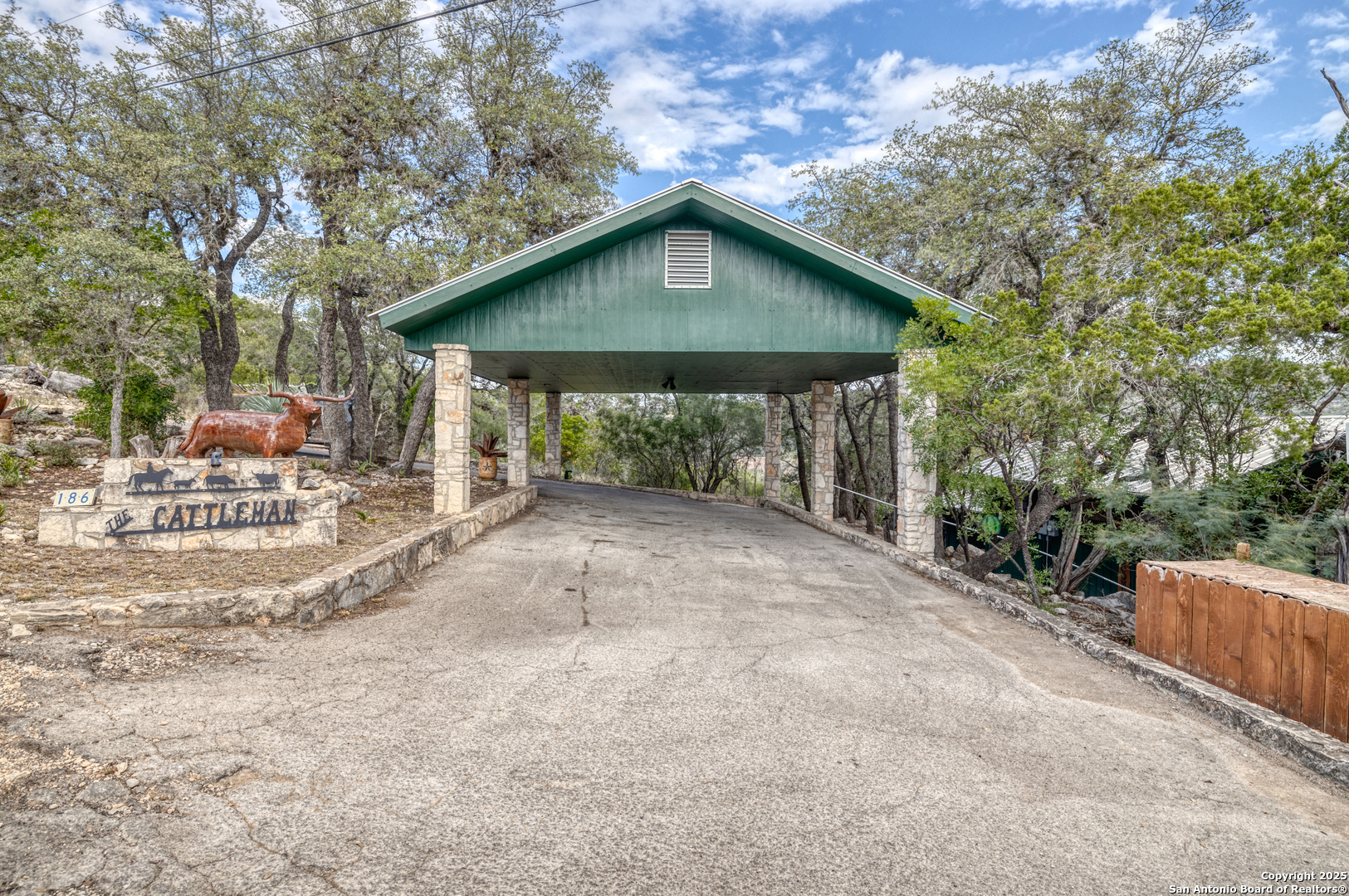 186 Cat Claw Mountain Road Concan, TX 78838 - Photo 31 of 31 a view of a house with a yard