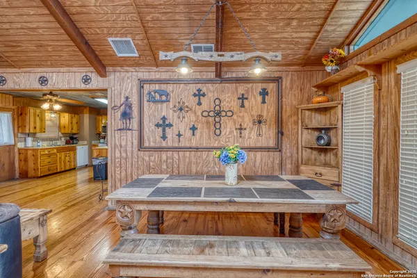 a view of a patio with couches chairs and wooden floor
