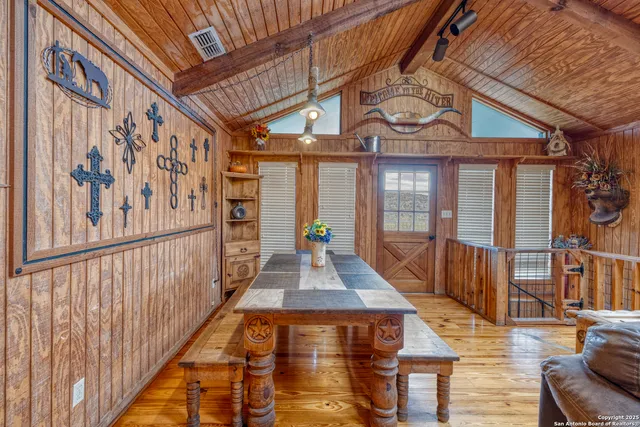 a kitchen with granite countertop a sink a counter space wooden floor and stainless steel appliances