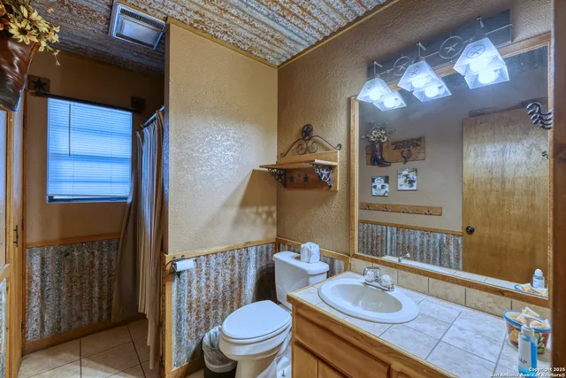 a bed sitting in a spacious bedroom next to a window