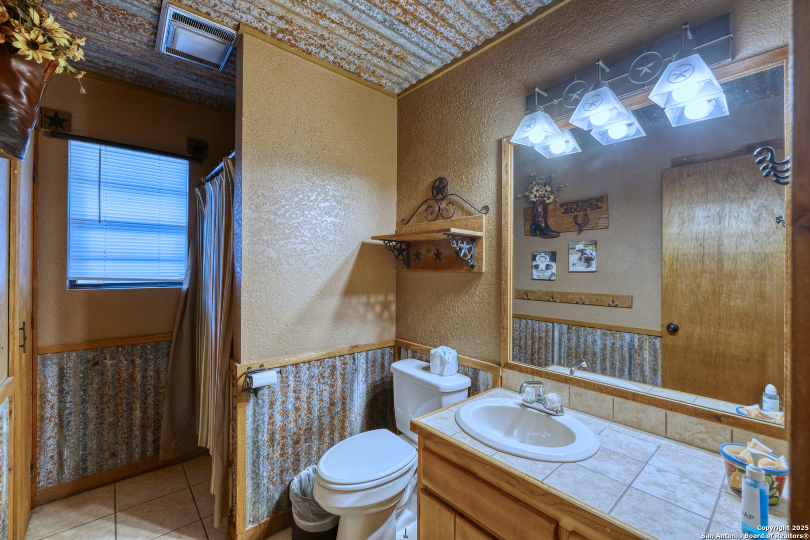 186 Cat Claw Mountain Road Concan, TX 78838 - Photo 10 of 31 a bathroom with a granite countertop bathtub sink vanity mirror and toilet