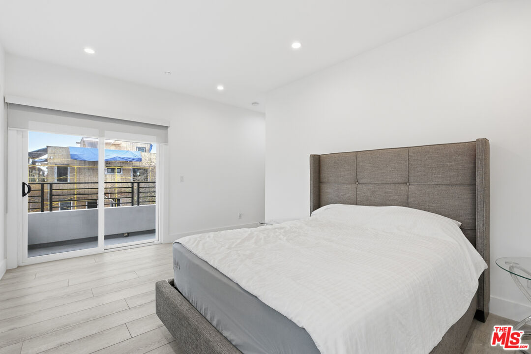 13822 Oxnard Street Van Nuys, CA 91401 - Photo 11 of 23 a bedroom with a bed and window