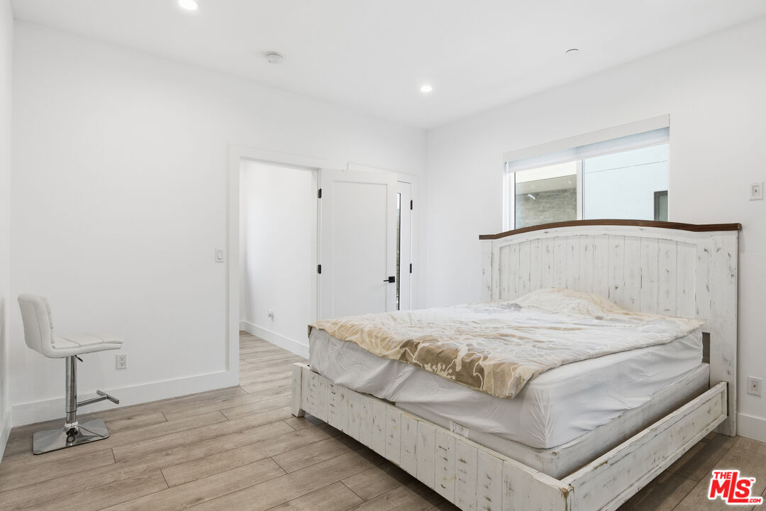 13822 Oxnard Street Van Nuys, CA 91401 - Photo 14 of 23 a bedroom with a bed and a table