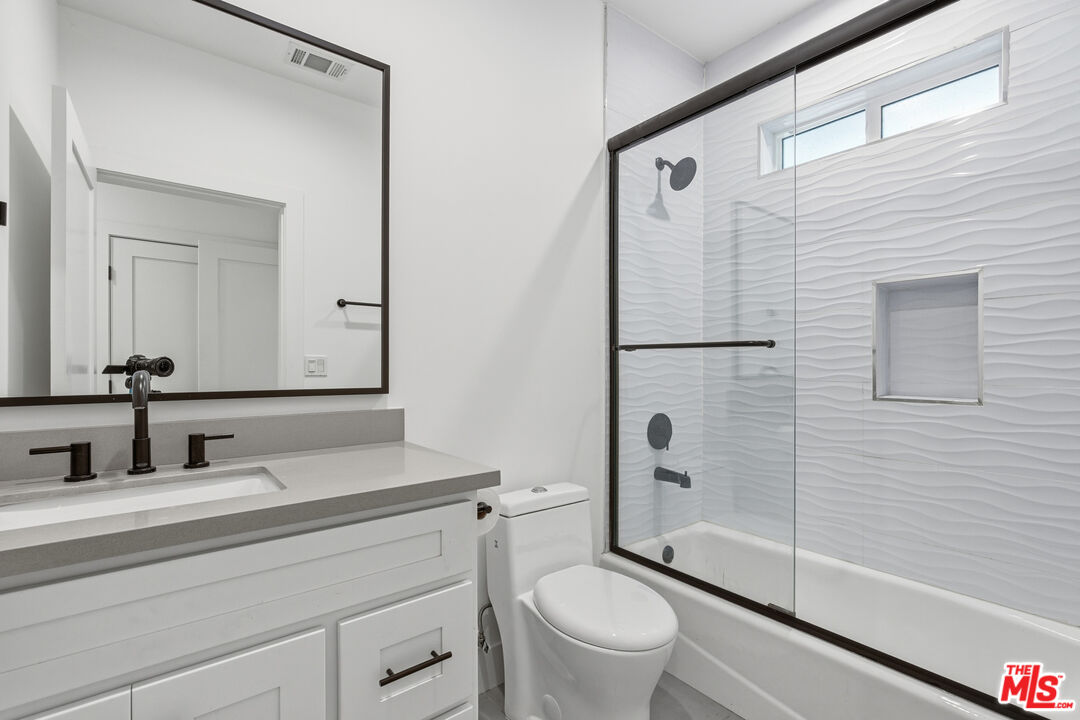 13822 Oxnard Street Van Nuys, CA 91401 - Photo 18 of 23 a bathroom with a sink a toilet and shower