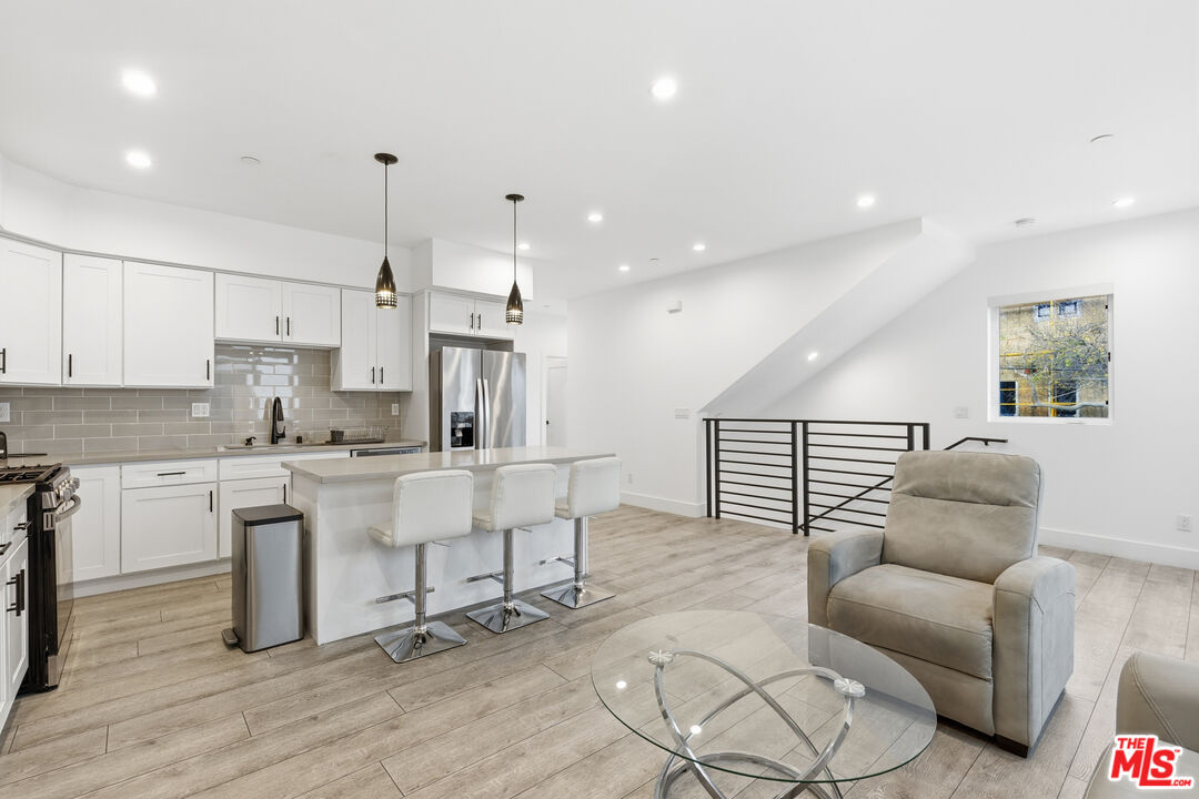 13822 Oxnard Street Van Nuys, CA 91401 - Photo 6 of 23 a living room with furniture and kitchen view