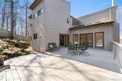 a view of a dinning table and chairs in patio of the house