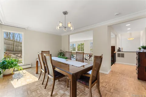 a kitchen with a dining table chairs and white appliances