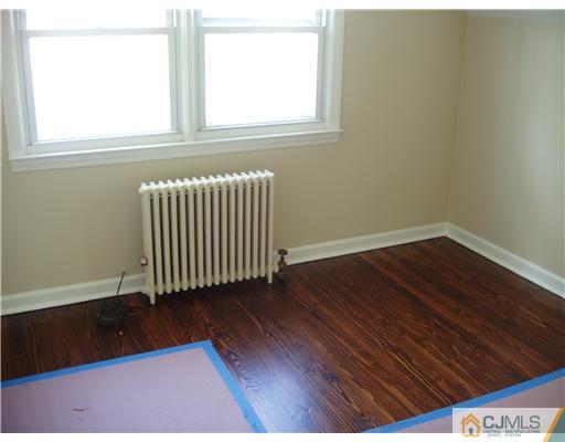 135 Midfield Road Colonia, NJ 07067 - Photo 12 of 18 a view of a room with wooden floor and a window
