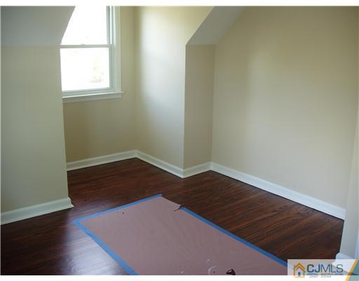 135 Midfield Road Colonia, NJ 07067 - Photo 13 of 18 an empty room with wooden floor