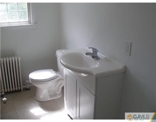 135 Midfield Road Colonia, NJ 07067 - Photo 14 of 18 a bathroom with a sink toilet and window