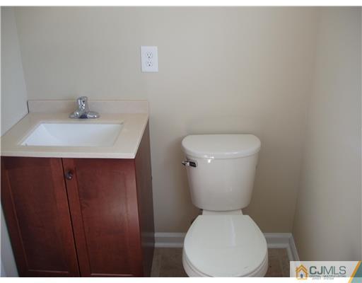 135 Midfield Road Colonia, NJ 07067 - Photo 16 of 18 a white toilet sitting next to a bathroom sink