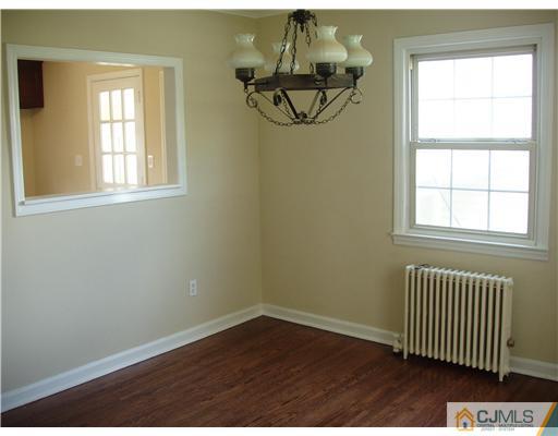 135 Midfield Road Colonia, NJ 07067 - Photo 6 of 18 an empty room with a window and wooden floor