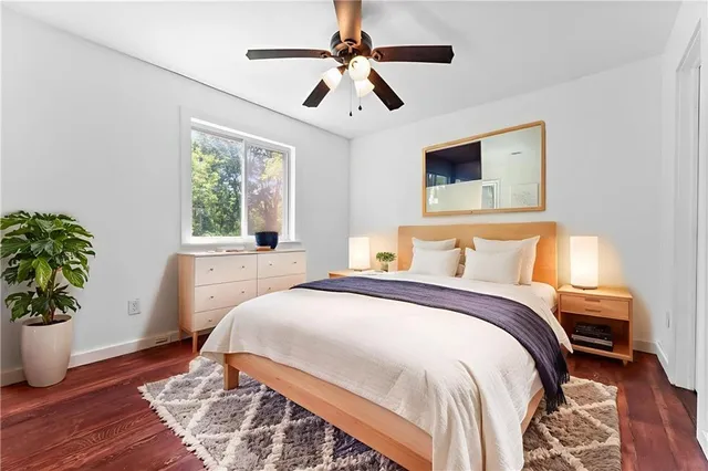 a bedroom with bed and a potted plant