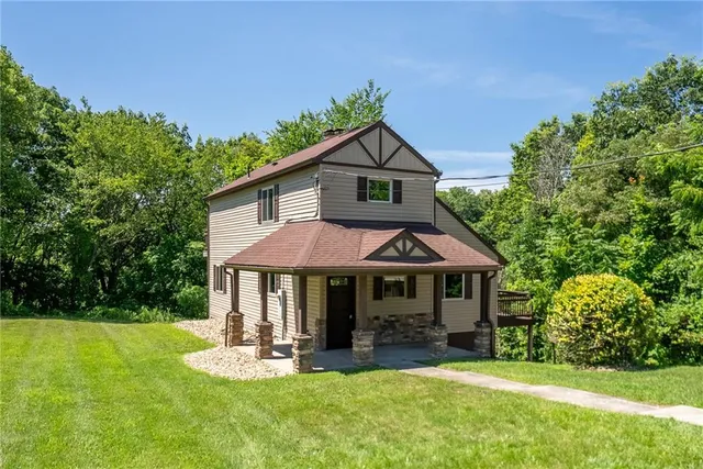 a front view of a house with a yard