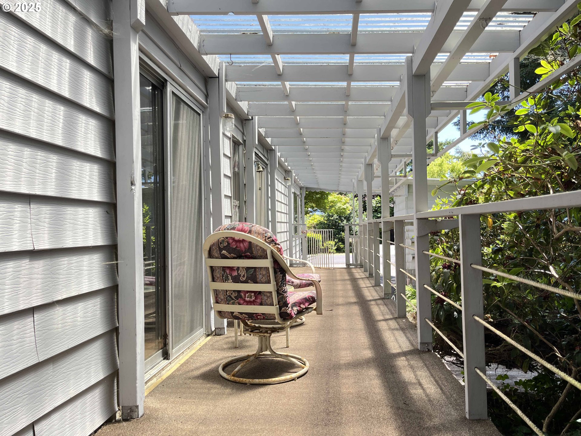1600 Rhododendron Drive, Unit 261 Florence, OR 97439 - Photo 33 of 42 a view of a balcony with chairs and a potted plant