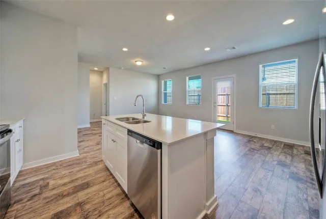 a kitchen with stainless steel appliances granite countertop a sink stove and microwave