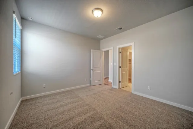 an empty room with windows and closet