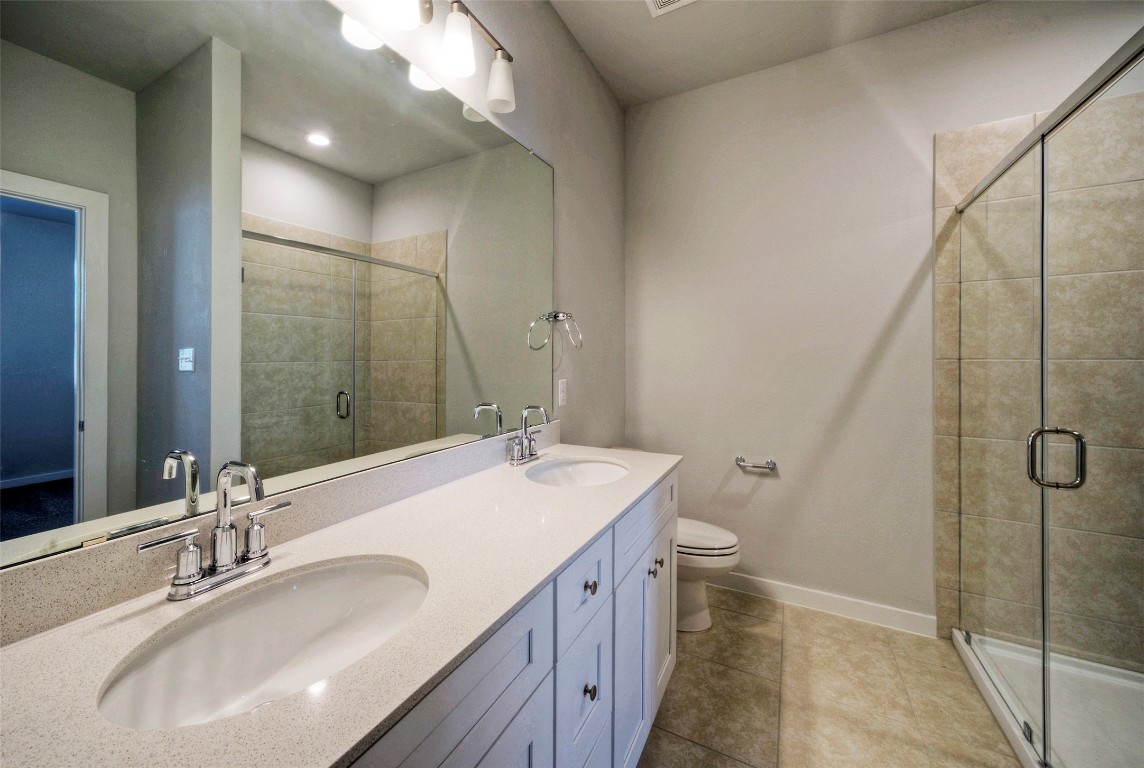 2312 Castillo Drive Round Rock, TX 78664 - Photo 15 of 21 a bathroom with a granite countertop sink toilet and shower