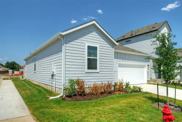a front view of house with a garden