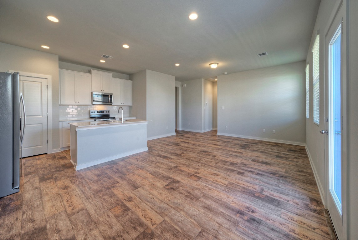 2312 Castillo Drive Round Rock, TX 78664 - Photo 21 of 21 a large kitchen with kitchen island a sink stainless steel appliances and cabinets