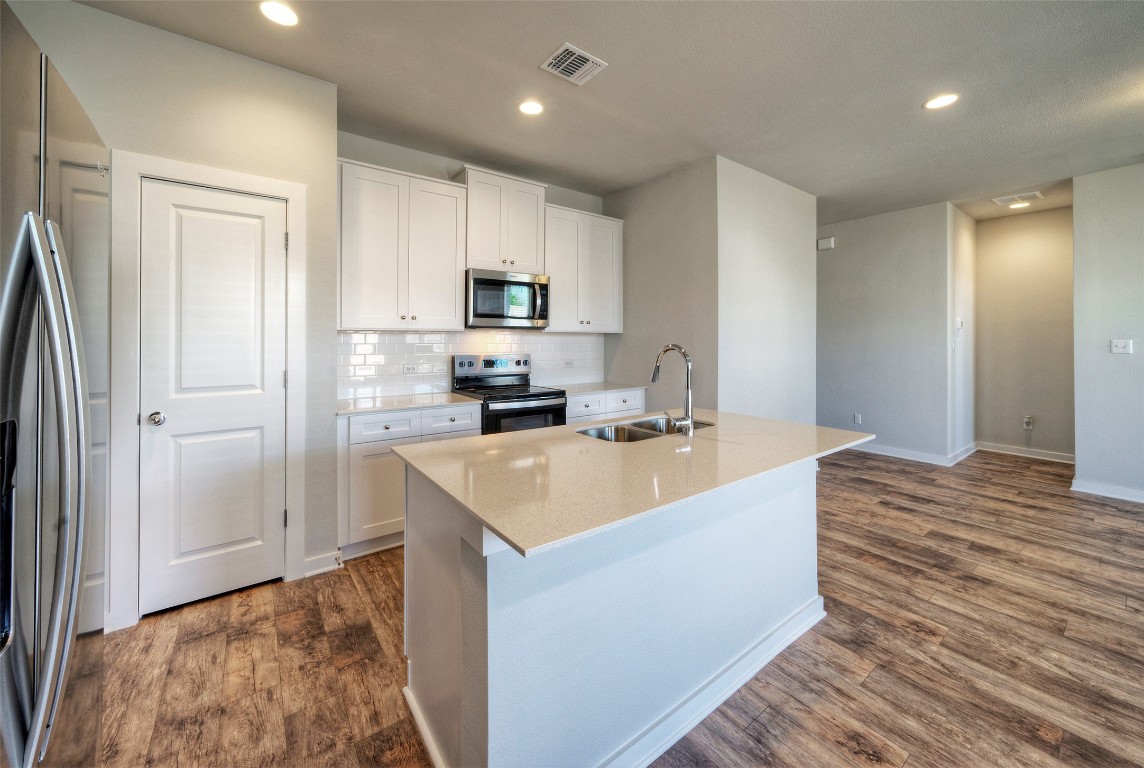 2312 Castillo Drive Round Rock, TX 78664 - Photo 8 of 21 a large kitchen with kitchen island a sink stainless steel appliances and cabinets