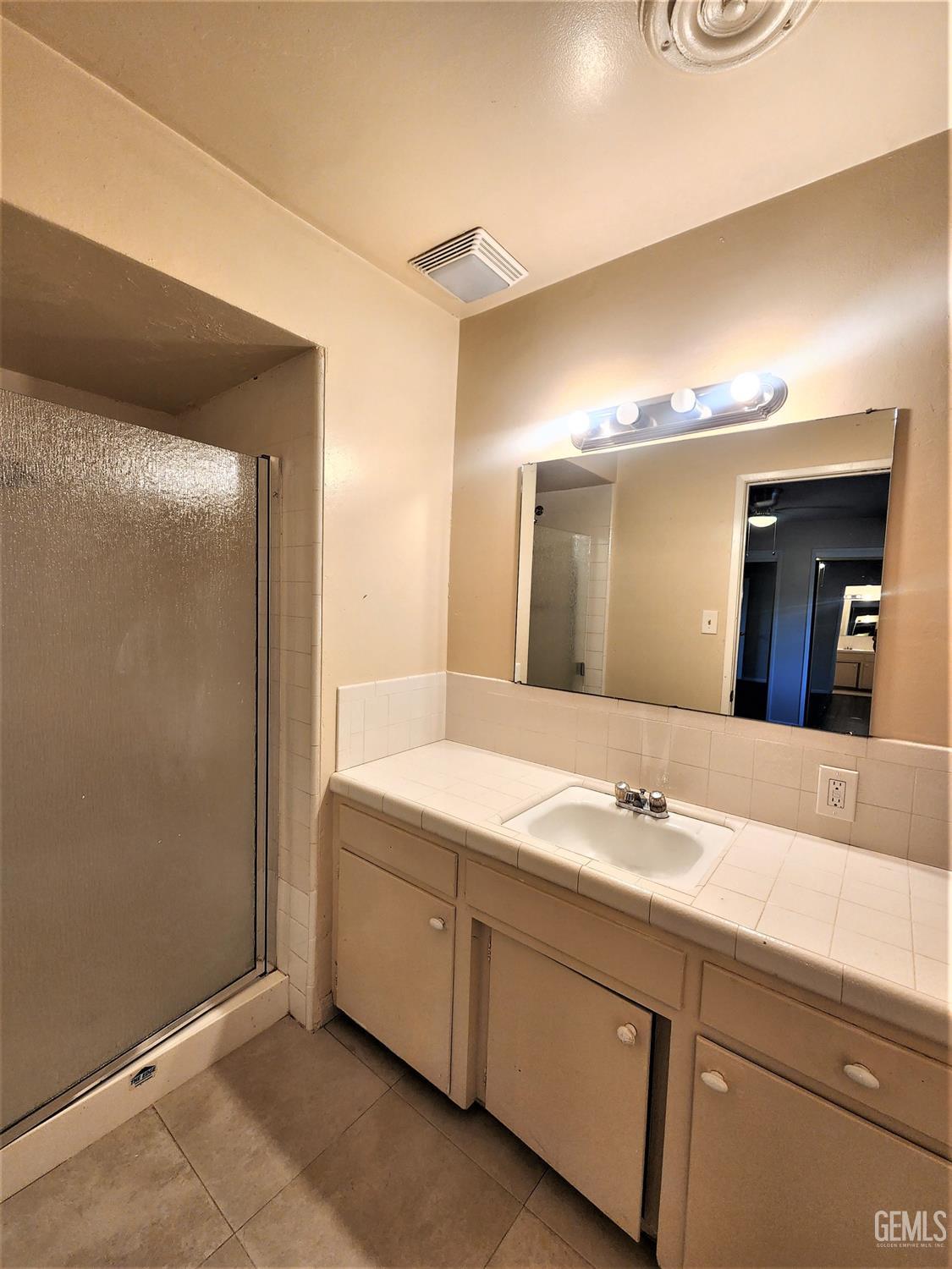 Undisclosed Address Bakersfield, CA 93306 - Photo 12 of 18 a bathroom with a double vanity sink and mirror