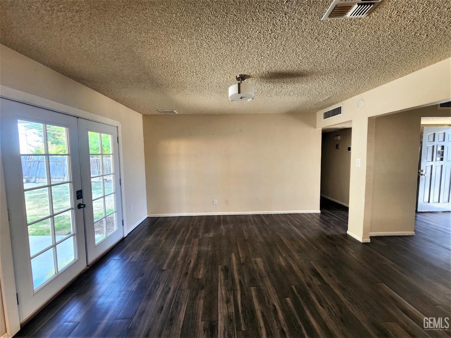 Undisclosed Address Bakersfield, CA 93306 - Photo 5 of 18 wooden floor in an empty room with a window