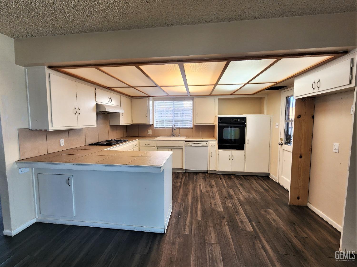 Undisclosed Address Bakersfield, CA 93306 - Photo 6 of 18 a kitchen with a sink and wooden floor