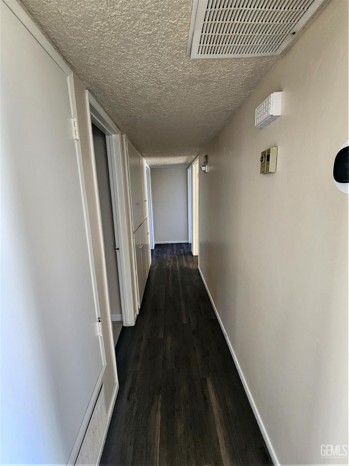 Undisclosed Address Bakersfield, CA 93306 - Photo 7 of 18 a view of a hallway with wooden floor