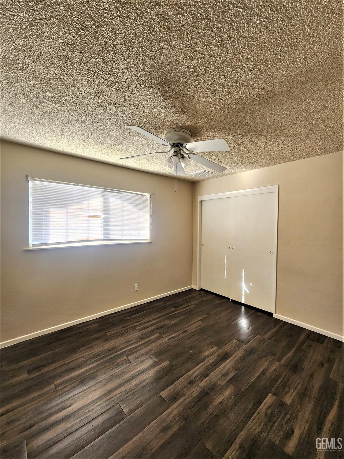 Undisclosed Address Bakersfield, CA 93306 - Photo 9 of 18 a view of an empty room with wooden floor and a window