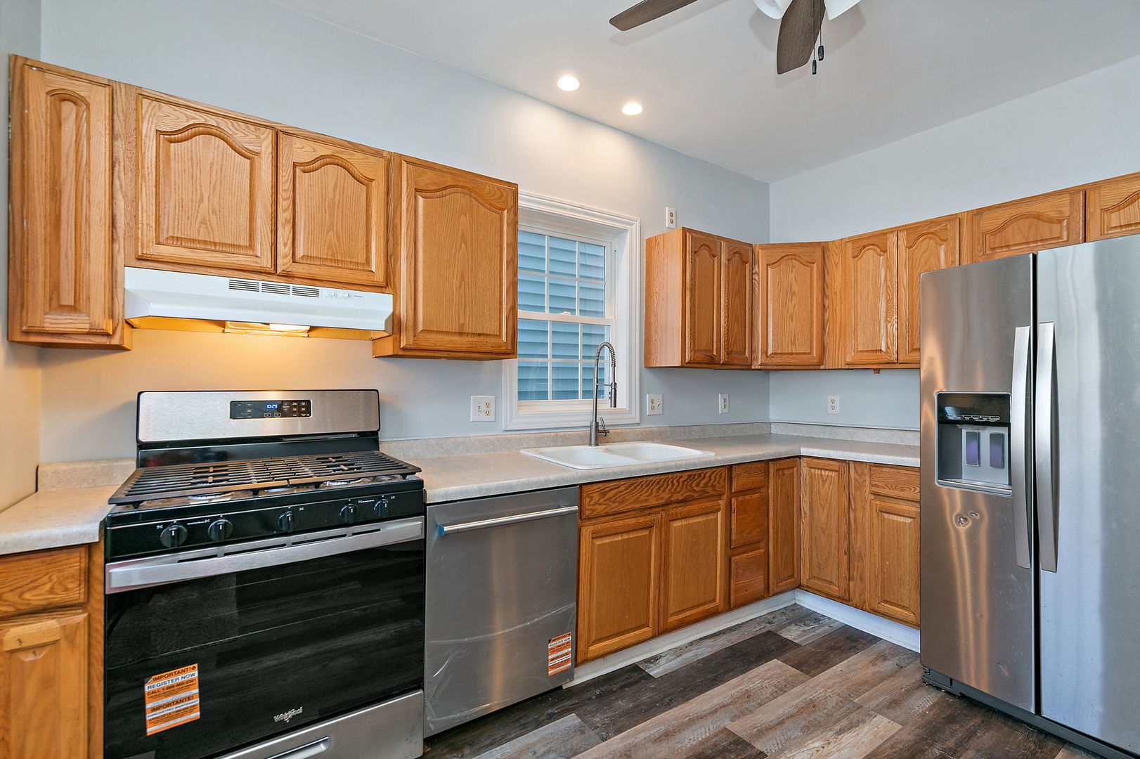 329 South 10th Street DeKalb, IL 60115 - Photo 11 of 25 a kitchen with stainless steel appliances a stove cabinets and a refrigerator