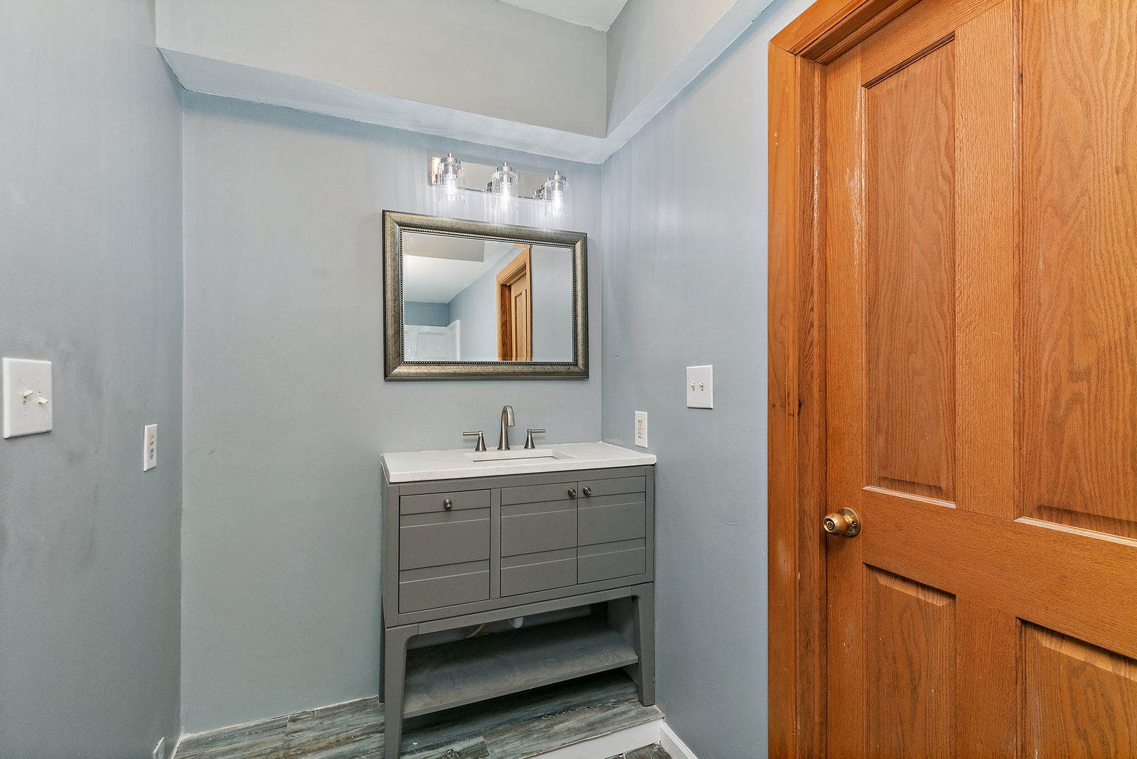 329 South 10th Street DeKalb, IL 60115 - Photo 12 of 25 a bathroom with a toilet a sink and mirror