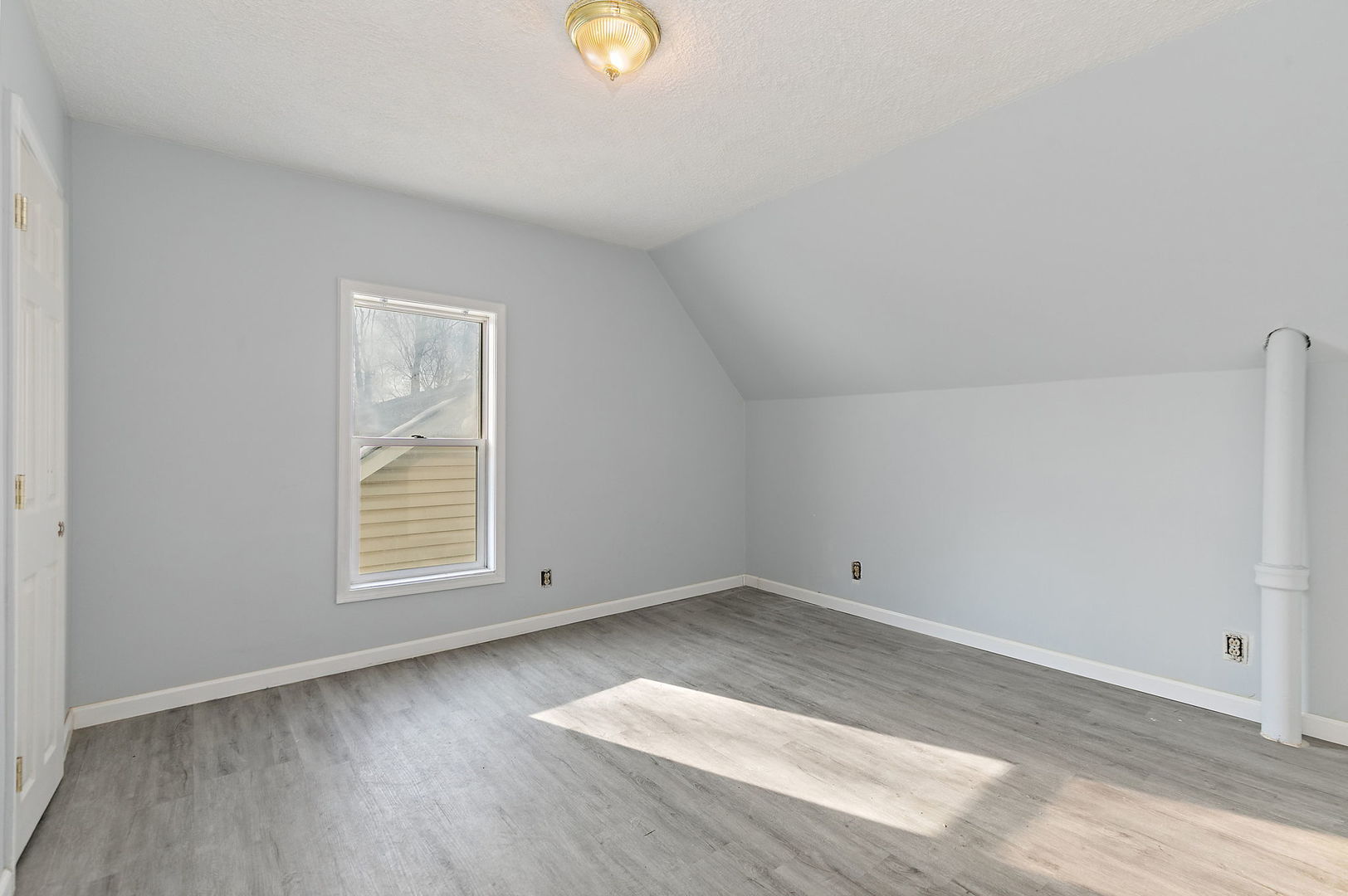 329 South 10th Street DeKalb, IL 60115 - Photo 18 of 25 an empty room with wooden floor and windows