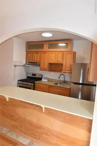 a kitchen with a sink and a stove top oven
