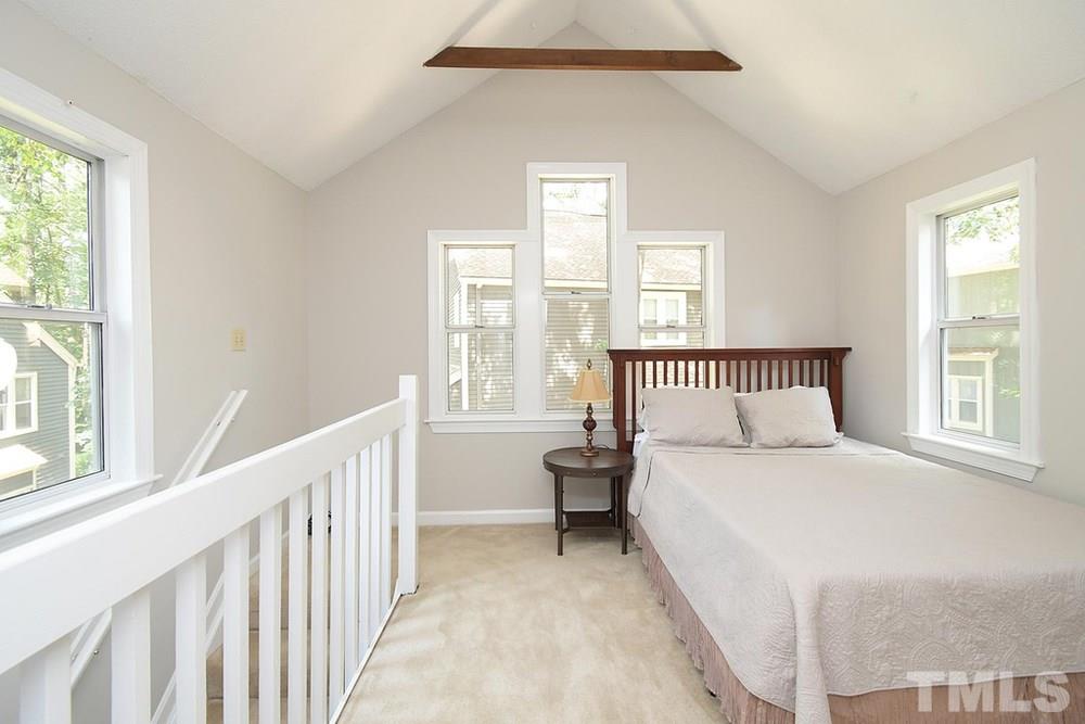 5903 Sentinel Drive Raleigh, NC 27609 - Photo 18 of 26 Lots of windows surround the room. Exposed beams overheard really show off this beautiful cathedral ceiling.