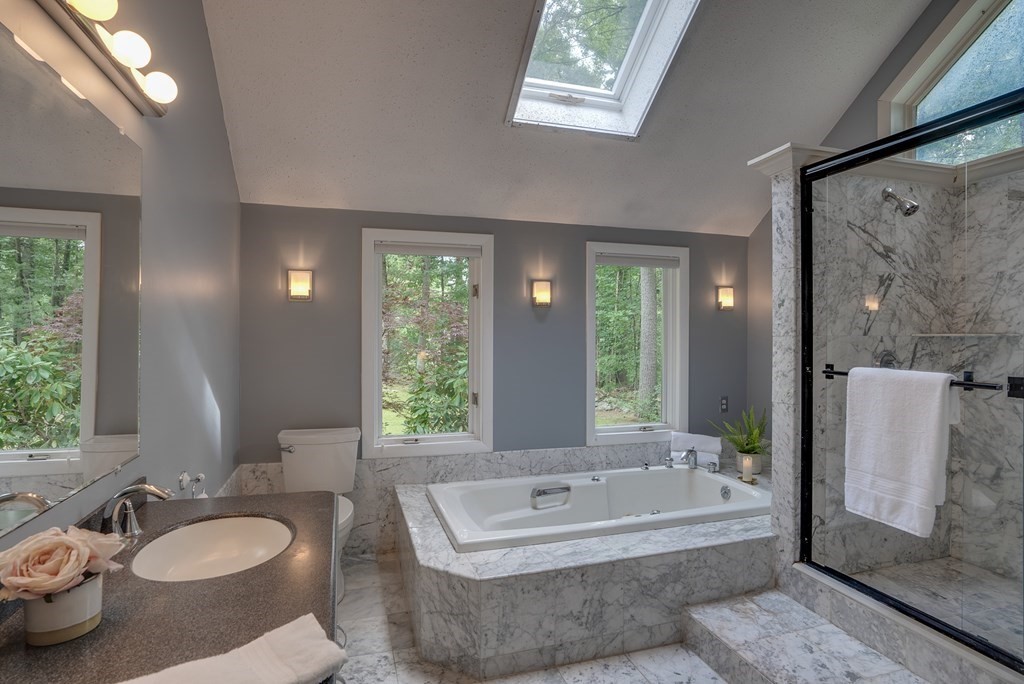 40 Tenney Road Rowley, MA 01969 - Photo 16 of 28 a bathroom with a granite countertop tub sink and mirror
