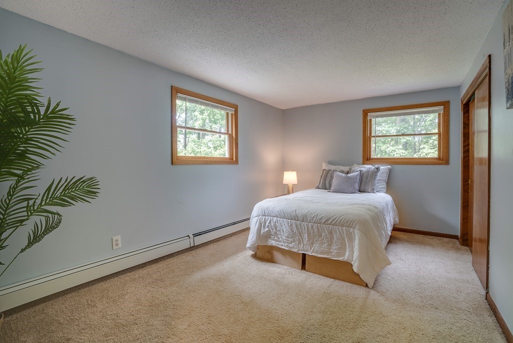 40 Tenney Road Rowley, MA 01969 - Photo 18 of 28 a bedroom with a bed and a window