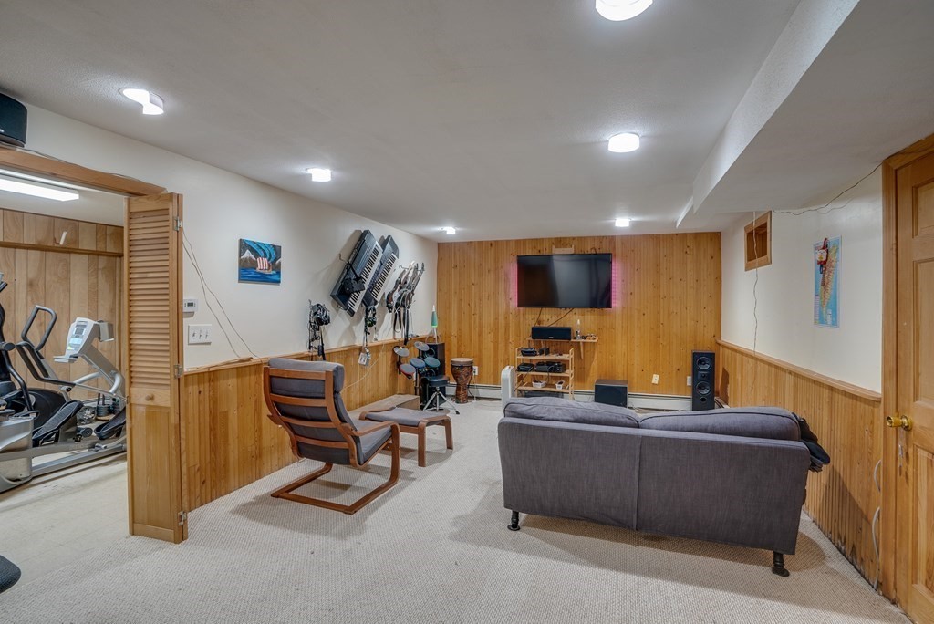 40 Tenney Road Rowley, MA 01969 - Photo 23 of 28 a living room with furniture and a flat screen tv