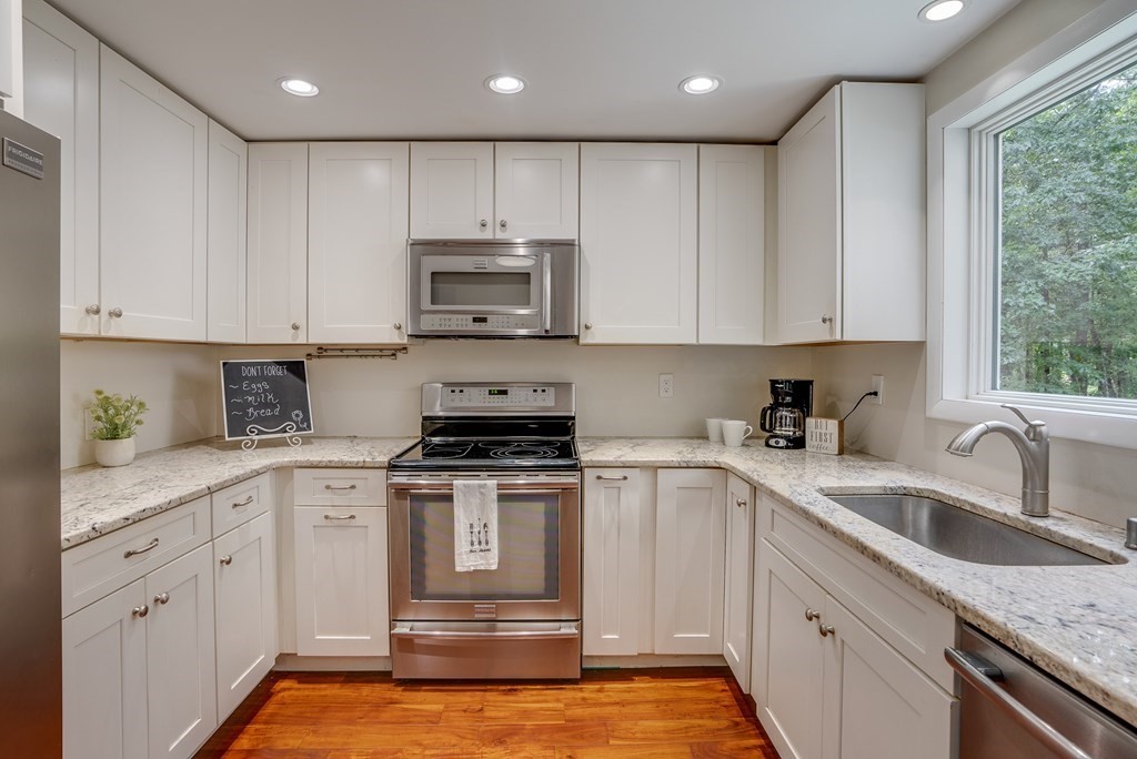 40 Tenney Road Rowley, MA 01969 - Photo 10 of 28 a kitchen with cabinets appliances a sink and a window