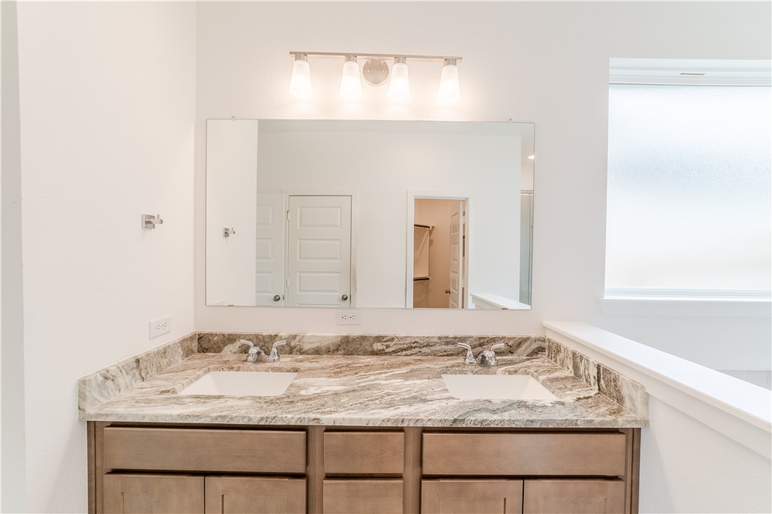 1901 Sebright Drive Bryan, TX 77807 - Photo 11 of 13 a bathroom with a granite countertop sink and a mirror