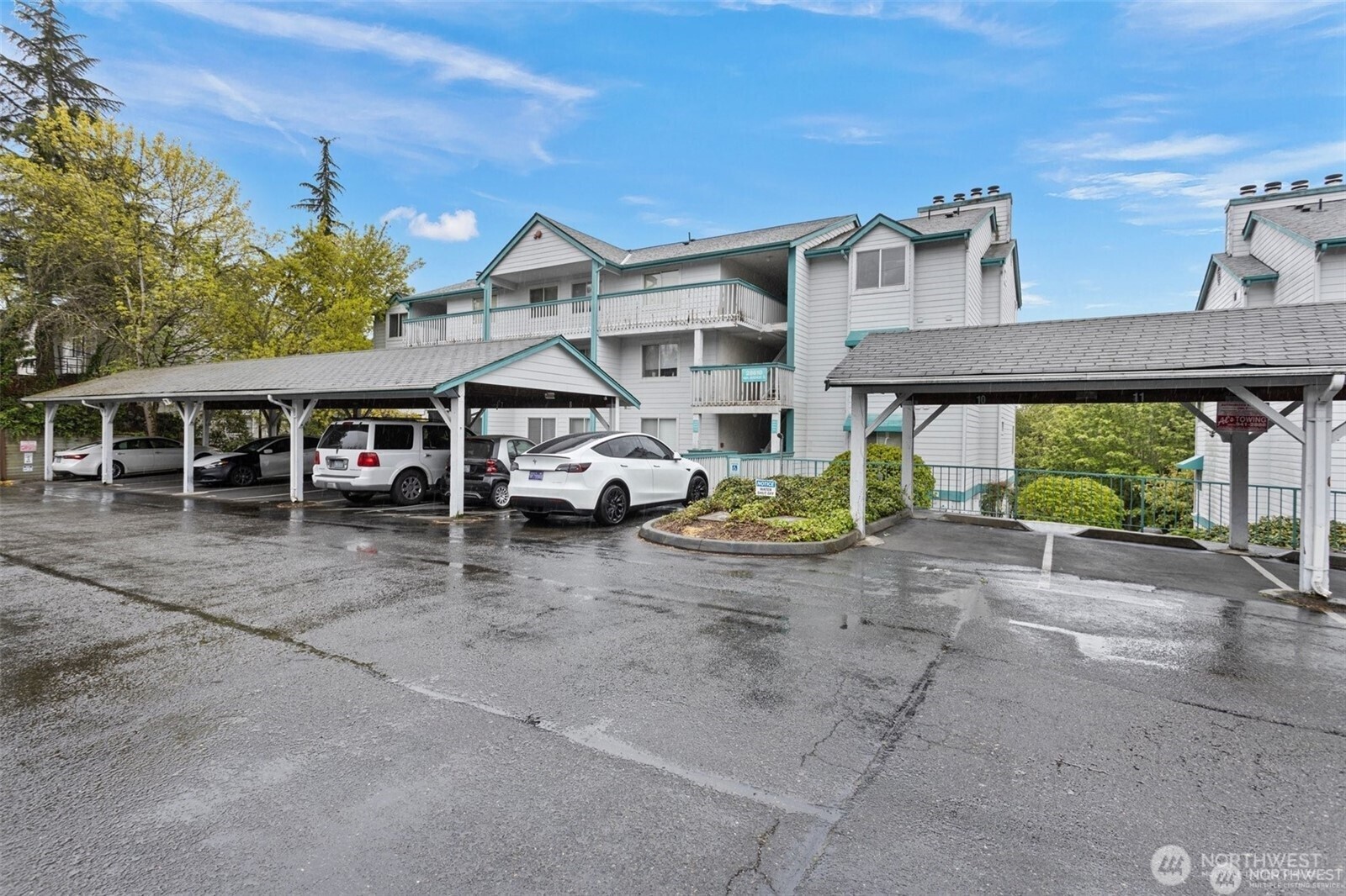 28606 16th Avenue South, Unit 102 Federal Way, WA 98003 - Photo 22 of 22 a view of a blue house with large windows and a car parked in front of it