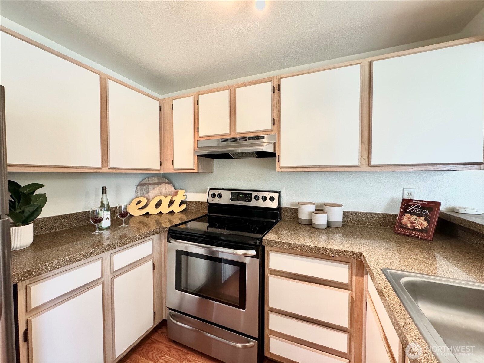 28606 16th Avenue South, Unit 102 Federal Way, WA 98003 - Photo 6 of 22 a kitchen with stainless steel appliances granite countertop a sink stove and cabinets