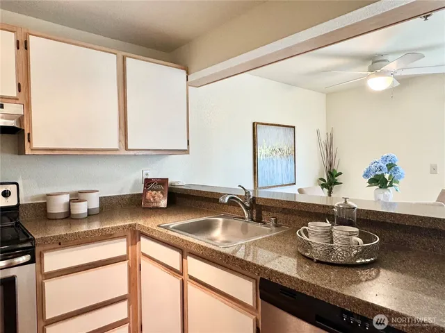 a kitchen with sink and a window