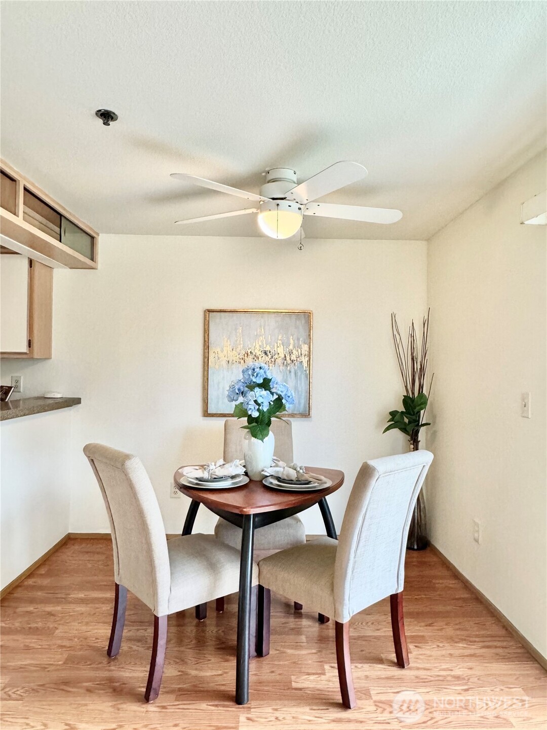 28606 16th Avenue South, Unit 102 Federal Way, WA 98003 - Photo 8 of 22 a dining room with furniture potted plants and wooden floor
