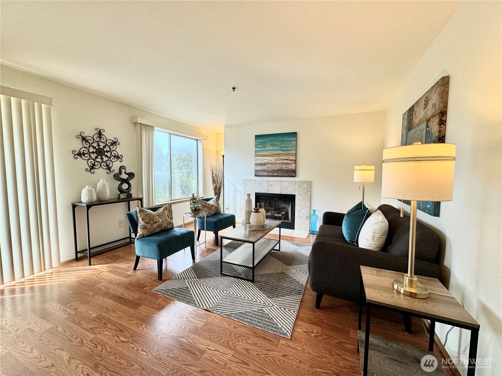 28606 16th Avenue South, Unit 102 Federal Way, WA 98003 - Photo 9 of 22 a living room with furniture a fireplace a lamp and a large window